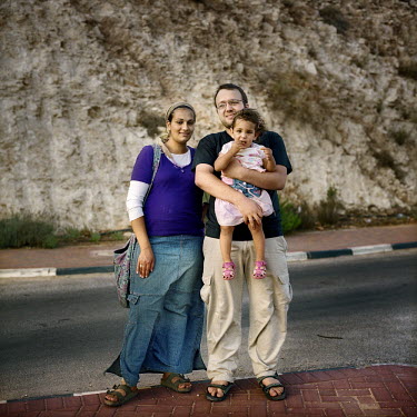 The Nabit family, Israeli settlers, stand at a junction next to the settlement of Psagot.
