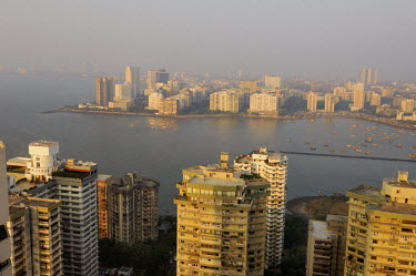 View over Mumbai from the World Trade Centre. In the foreground are luxury apartment buildings, facing on to Bank Bay, with Nariman Point business district beyond.