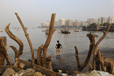 Fishermen on a small beach in Back Bay, a poor fishing community that stands in stark contrast to the office buildings of Nariman Point business district behind.