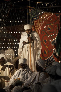 Celebrating the Prophet's birthday, a sheikh preaches to members of his tariqa (Sufi order), in Shendi. Sufism plays an important role in Sudan, Sufis believe a mystical path exists by which to reach...