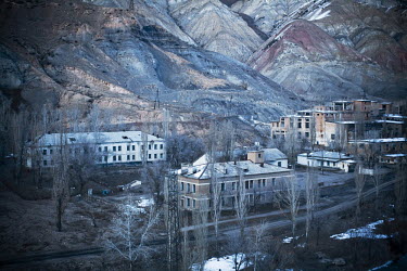 Dilapidated industrial buildings in Min Kush. During the 1960s and 70s, Min-Kush was a prosperous city living off the wealth of uranium mining. It is now an impoverished and semi-deserted village of 2...