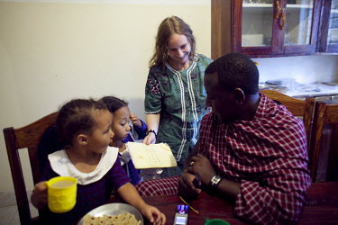 Gemma Enolengila eats breakfast with her husband Lesikar Olengila and daughters Lucia Ene-Lesikar, left and Suzie Ene-Lesikar at their home in Arusha. Gemma, who is British, worked with Lesikar (who i...