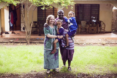 Gemma Enolengila stands with her family (from left) daughter Lucia Ene-Lesikar, husband Lesikar Olengila and daughter Suzie Ene-Lesikar outside their home in Arusha. Gemma, who is British, worked with...