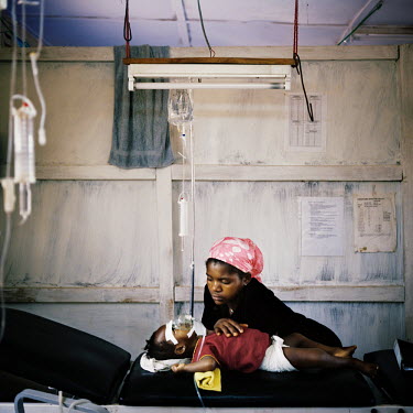 A malaria patient and his mother in the ICU (intensive care unit) at MSF (Medecins sans Frontieres) Gondama hospital in Bo.