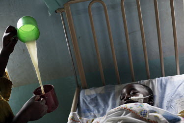 A young patient, with a severe case of malaria in a hospital in Kampala.