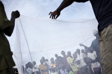 A free mosquito net distribution near Masindi.
