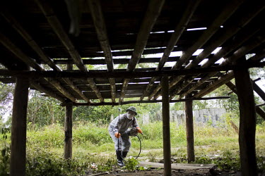 A man fogs a Karen village against mosquitoes in Northern Thailand. The technique of fogging, or area spraying, which aims at killing mosquitoes by contact with the insecticide in the air, has had ver...