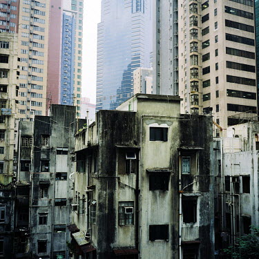 A poor residential area in front of a new office block in Hong Kong.