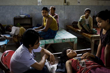 A patient with severe malaria lies on a table in Mae Tao clinic, Mae Sot.