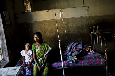 A malaria patient with his family in a small clinic in Orissa state.
