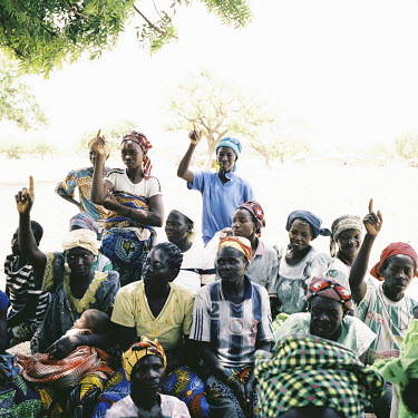 Women are taught about malaria in a remote village in Namentenga.