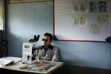 A microscopist in a malaria clinic in Mae Sot.