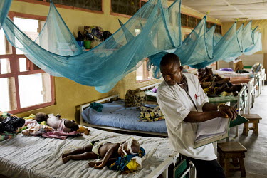 A doctor checks on a young malaria patient at MSF (Medecins sans Frontieres) Gondama hospital in Bo.