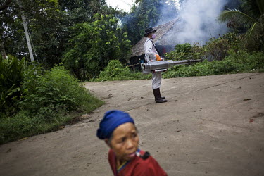 A man fogs a Karen village against mosquitoes in Northern Thailand. The technique of fogging, or area spraying, which aims at killing mosquitoes by contact with the insecticide in the air, has had ver...