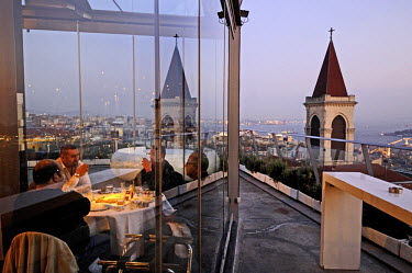 People eating at the dramatic glass-walled restaurant and night club '360'. Built on the top of a grand nineteenth century building on Istiklal Cadessi, the main high street of European Istanbul in th...