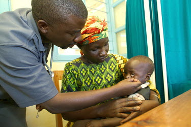 A small boy is treated for malaria by a doctor in a health centre.