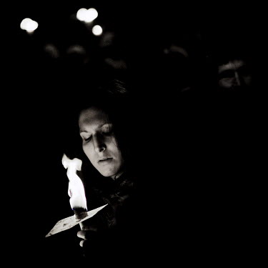 A protestor holds a candle at a rally at the UN summit on climate change (COP15) in Copenhagen. At this rally, 100,000 people gathered carrying lights to make their protest.