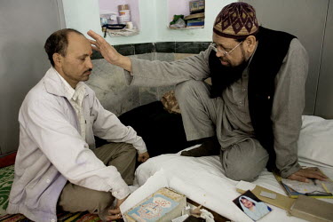 A mentally ill man is examined by Mohammed Omar Faridi, a pir at the Shareef Dargah in New Delhi. Delhi is typical of many Indian cities in that it has very few trained psychiatrists and many people s...