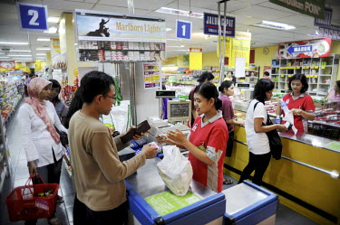 Supermarket checkouts inside a shopping mall.