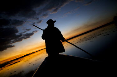 A guide poles his way through the wetlands of Bangweulu.