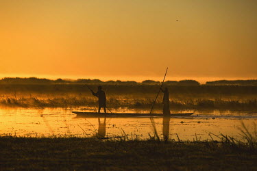 Men travel on a canoe on lake Bangweulu.