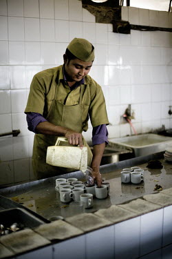 A worker washes cups in the kitchen of the Indian coffee house, Baba Kharak Singh Marg. The coffee house dates back almost fifty years, first in central Connaught Place, then Janpath and now at the to...