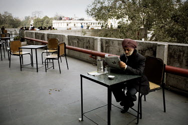 A man reads a newspaper on the roof terrace of the Indian Coffee house, Baba Kharak Singh Marg. The coffee house dates back almost fifty years, first in central Connaught Place, then Janpath and now a...