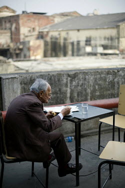 An elderly man eats his lunch on the roof terrace of the Indian coffee house, Baba Kharak Singh Marg. The coffee house dates back almost fifty years, first in central Connaught Place, then Janpath and...