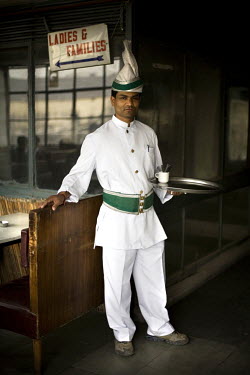 A waiter with a turbaned headress and cumberbund in the Indian coffee house, Baba Kharak Singh Marg. The coffee house dates back almost fifty years, first in central Connaught Place, then Janpath and...