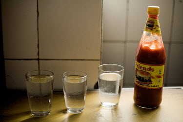 A bottle of ketchup and three glasses of water in the Indian coffee house, Baba Kharak Singh Marg. The coffee house dates back almost fifty years, first in central Connaught Place, then Janpath and no...