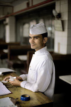 A waiter at the cash desk in the Indian coffee house, Baba Kharak Singh Marg. The coffee house dates back almost fifty years, first in central Connaught Place, then Janpath and now at the top of a rat...