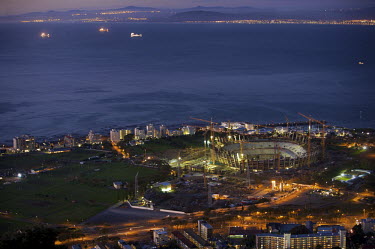 A view at night of the Cape Town Stadium at Green Point, overlooking ships in Table Bay. The stadium is one of 10 stadia in South Africa that will host the 2010 FIFA football World Cup.