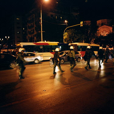 Police in full riot gear approaching a student demonstration during the financial crisis.