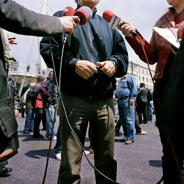 A worker being interviewed about the Piraeus Port workers' strike during the financial crisis.