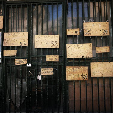 A wood workshop displaying its prices on the entrance door.