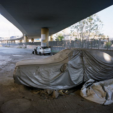 Abandoned cars under a motorway bridge during the financial crisis.