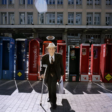 An old man exiting a Metro station.
