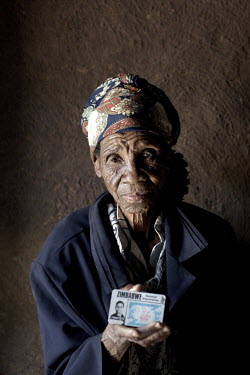 94 year old Golidem holds her identity (ID) card in a small hut in rural Zimbabwe.