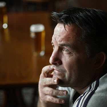 A man watching television in the Cross Keys pub, in Paulsgrove, near Portsmouth. Almost all of the patrons of the pub are local people who know each other well and meet at the pub everyday. This is th...