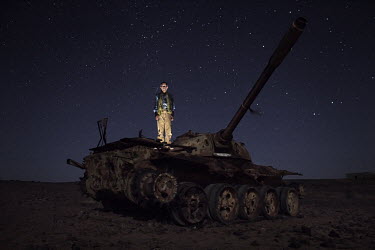 Hamdi Jaafar Mohammed, 46, Soldier of the Polisario Front. Pictured atop a tank in Tifariti, in Polisario controlled Western Sahara (Saharawi Arab Democratic Republic): 'I was born in 1963 in Wagcedhi...