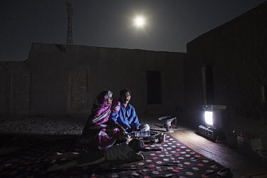 Ali Salem Salma, 41, statistician for the Saharawi government. Pictured watching TV at home with his wife, Nabba, and four year old son, Khadda, in Smara refugee camp, Algeria: 'I was born in El Aaiun...