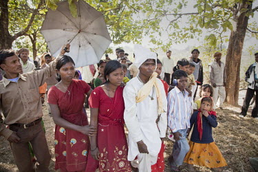 Sunil Tudu, in white, is led by his family through his bride-to-be's village on their wedding day: One of the wedding traditions of the Santhal Adivasi tribal people.