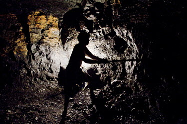 A miner works underground in a small non-mechanized coal mine. In the wake of displacement by large scale, government backed, open pit mining, the economy of Jharkhand is changing as many smaller arti...