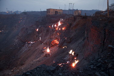 Buildings collapse into a fiery abyss. Due to the spread of open pit mining in areas where underground mines were previously operated, thousands of uncontrolled coal fires have broken out as oxygen ha...