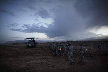 US Army soldiers from HQ Company 1-503rd Infantry, 173rd Airborne, carry the body of SPC Wade Slack, EOD 192D Ordnance Battalion, who was killed by rocket shrapnel during a Taliban attack to a waiting...