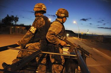 At dusk, an army patrol travels through the outskirts of the border town of Ciudad Juarez, which is plagued by drug related violence. Drug cartels fight over control of lucrative smuggling routes whil...