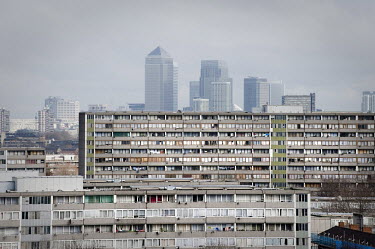 Canary Wharf in the distance behind the Aylesbury Estate in Walworth, Southwark, London. Most of the estate, which houses some of the poorest people in the country, is due for demolition within the ne...