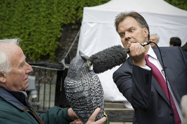 BBC reporter Matt Frei hits a toy owl with a microphone on College Green in Westminster, London on the day after the general election took place.