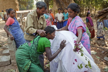 Villagers cover a megalith with a cloth during a ceremony to mark the anniversary of their ancestor's death. Traditionally animist, Adivasi communities erect megaliths as part of their belief in ances...
