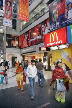 Middle-class shoppers at the Metropolitan Mall, an upmarket shopping centre in the Delhi suburb of Gurgaon. The mall contains outlets for many global brands such as McDonald's, Marks and Spencer and T...